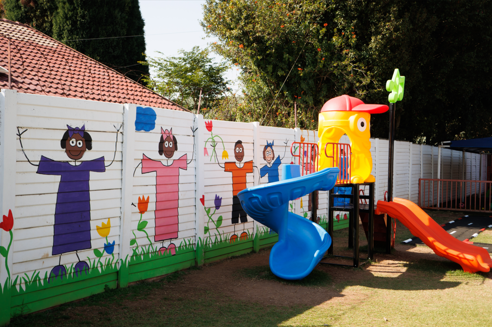Millennium Kids Montessori playground with slides, swings and jungle gyms